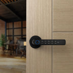 A modern black digital smart door lock with a horizontal handle and blue fingerprint感应 ring, mounted on a light wood paneled door with a blurred interior room in the background.